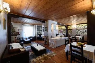 a living room with tables and chairs in a room at TWO BEDROOM Apartment in Bansko