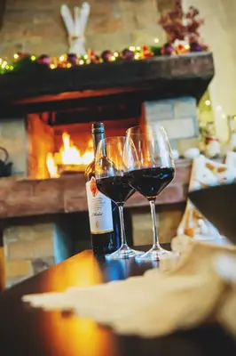 two glasses of red wine next to a bottle of wine at TWO BEDROOM Apartment in Bansko