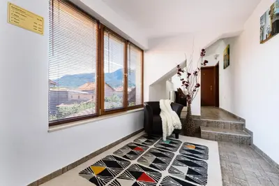 a hallway with a window and a rug at TWO BEDROOM Apartment in Bansko