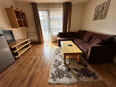 a living room with a couch and a coffee table at Top Lodge twobedroom apartment in Bansko