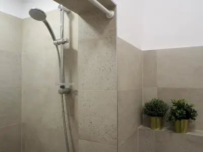 a shower with a shower head in a bathroom at Caché - Bright One-Bedroom Apartment in Sofia by Flat Mаnager in Sofia