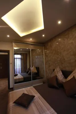 a bedroom with a bed and a large mirror at Brown Cottage Apartment in Sofia
