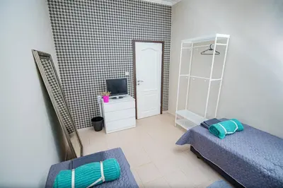 a small bedroom with two beds and a television at Huge Stylish Apartment Monroe 1 / City Centre in Plovdiv