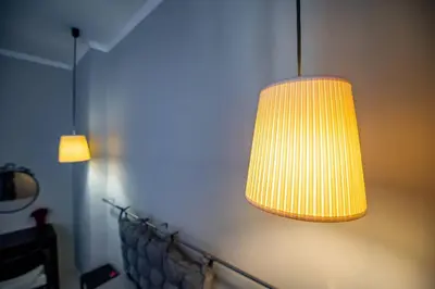 a lamp hanging from a wall in a room at Huge Stylish Apartment Monroe 1 / City Centre in Plovdiv