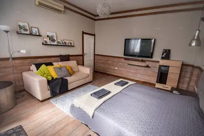 a living room with a couch and a flat screen tv at Huge Stylish Apartment Monroe 1 / City Centre in Plovdiv