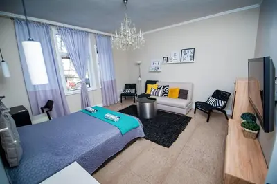 a bedroom with a blue bed and a couch at Huge Stylish Apartment Monroe 1 / City Centre in Plovdiv