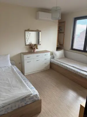 a bedroom with two beds and a mirror at Apartament Emi in Sandanski