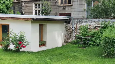 a white house with a table in a yard at Ancient Serdica 2BDR Family Friendly City Retreat in Sofia