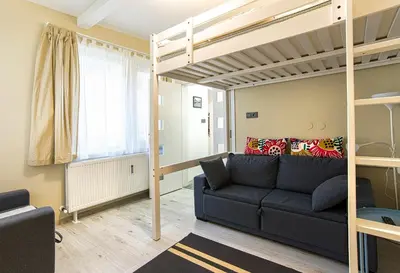 a living room with a couch and a bunk bed at Ancient Serdica 2BDR Family Friendly City Retreat in Sofia