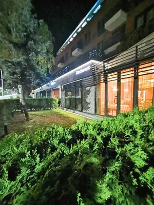 a view of a building at night at Aqua Viva Spa Hotel in Velingrad