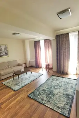 a living room with a couch and a table at Aqua Viva Spa Hotel in Velingrad
