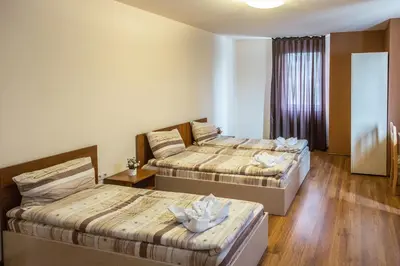 a hotel room with two beds and a window at Hotel West in Blagoevgrad
