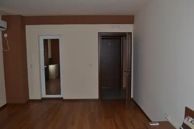 an empty room with white walls and wood floors at Hotel West in Blagoevgrad