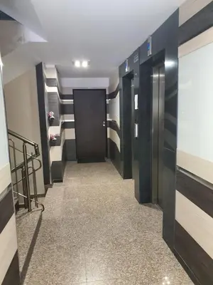 a hallway with a black door and a walk in closet at VIP apartment & parking in Sofia