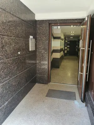 a hallway of a building with a door and a hallway at VIP apartment & parking in Sofia