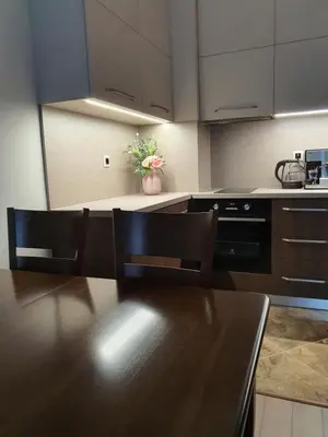 a kitchen with a table and chairs and a stove at VIP apartment & parking in Sofia