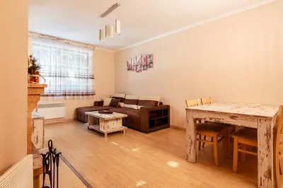 a living room with a couch and a table at Lake View Apartment in Pamporovo