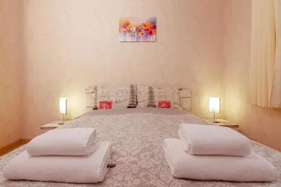 a bedroom with a bed with two pillows on it at Lake View Apartment in Pamporovo