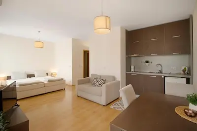 a large living room with a couch and a kitchen at Fantastic Studio Studentski Grad in Sofia