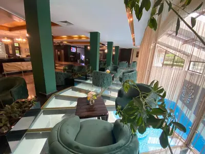 a lobby with couches and potted plants at Hotel Iceberg Borovets in Borovets