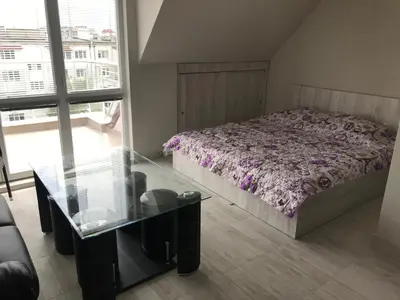 a bedroom with a bed and a glass table at NORTH PARK SUITE in Sofia