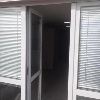 an open door to a hallway with blinds at NORTH PARK SUITE in Sofia