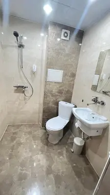 a bathroom with a toilet and a sink and a shower at Apartment City Park Sandanski in Sandanski