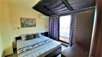 a bedroom with a bed and a window at Sunny Days - Park Apartment in Sandanski