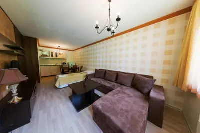 a living room with a couch and a table at Aparthotel Forest Nook in Pamporovo