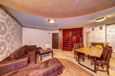 a living room with a couch and a table at Вили Forest Nook in Pamporovo
