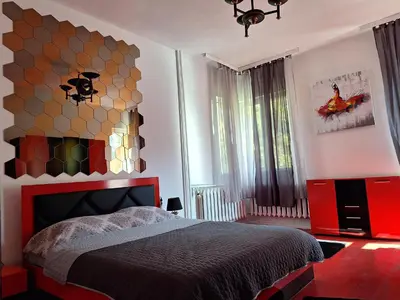a bedroom with a large bed with a colorful wall at TOP CENTER spacious apartment with free parking in Sofia
