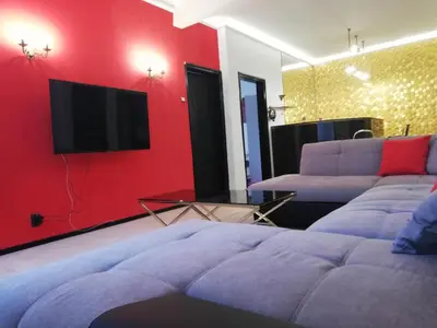 a living room with a couch and a flat screen tv at TOP CENTER spacious apartment with free parking in Sofia