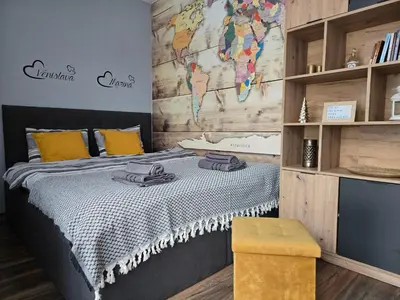 a bedroom with a bed with a map on the wall at Sunny Apartment in Blagoevgrad