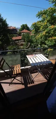 a patio with a table and chairs on a balcony at Sunny Apartment in Blagoevgrad