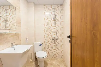 a bathroom with a toilet and a sink and a shower at Къща за гости Перуника in Sapareva Banya