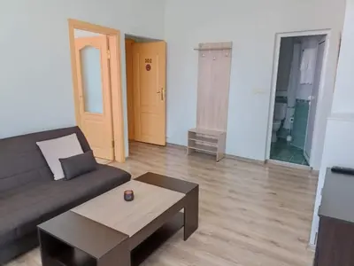 a living room with a couch and a coffee table at Приятелската къща in Velingrad