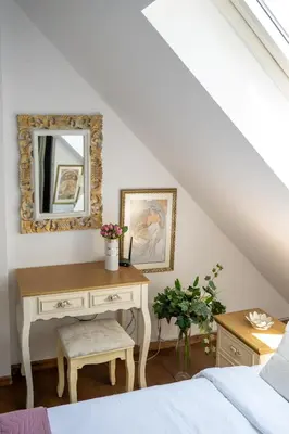 a bedroom with a desk with a mirror and a bed at Sunny Studio with a view in TOP Center in Sofia
