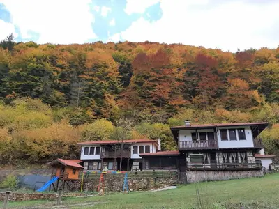 a house sitting on top of a green field at Къща за гости 