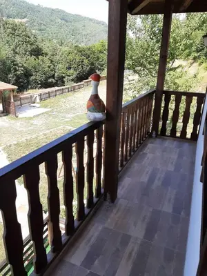 a vase sitting on a railing on a porch at Къща за гости 