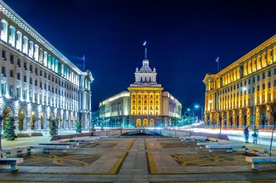 a lit up building in a city at night at Top Center Apartment next to Vitosha Boulevard in Sofia