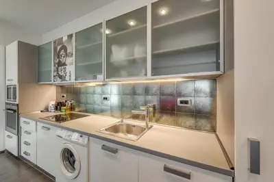 a kitchen with a sink and a washing machine at Top Center Apartment next to Vitosha Boulevard in Sofia
