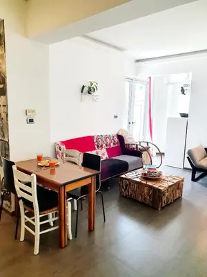 a living room with a table and a couch at Top Center Apartment next to Vitosha Boulevard in Sofia