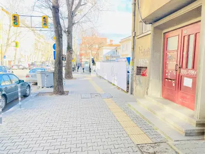 a sidewalk with a red door on a city street at Beautiful Jewel in Top Center in Sofia