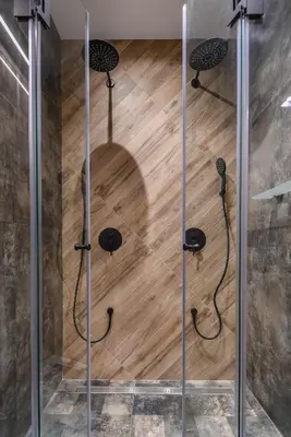 a shower in a room with a wooden floor at Sofia Dream Apartment - The Library - 3-BDR, 2-BTHR by Flat Mаnager in Sofia