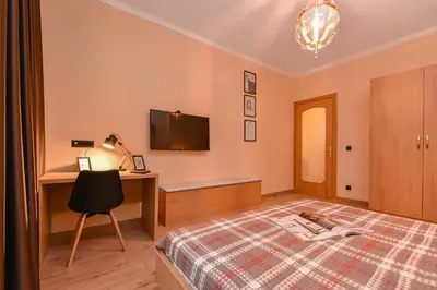 a bedroom with a bed and a desk and a television at Sofia Dream Apartment - The Library - 3-BDR, 2-BTHR by Flat Mаnager in Sofia