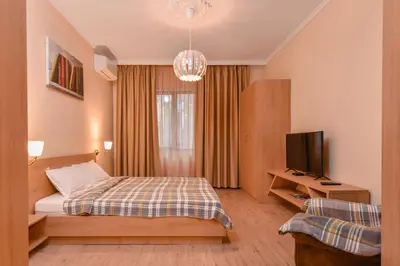 a hotel room with a bed and a television at Sofia Dream Apartment - The Library - 3-BDR, 2-BTHR by Flat Mаnager in Sofia