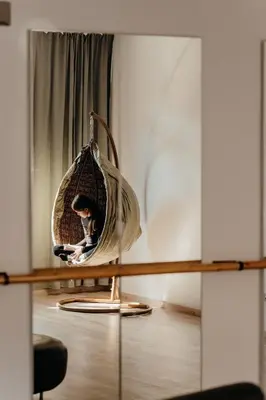 a person sitting in a swing in a room at Magnificent apartment in the mountains in Banite
