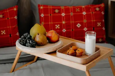 a table with a tray of fruit and a glass of milk at Magnificent apartment in the mountains in Banite