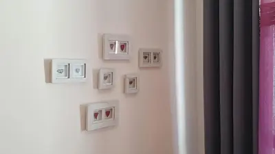 a wall with pictures on a white wall at Borovets Holiday Homes in Borovets