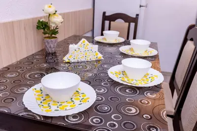 a table with three cups and plates on it at Къща за гости Калинови in Sandanski